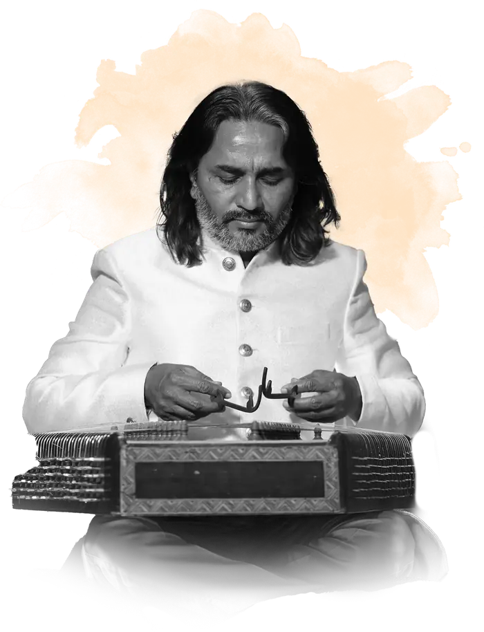 Ustad Nawab Khan seated cross-legged, playing the santoor