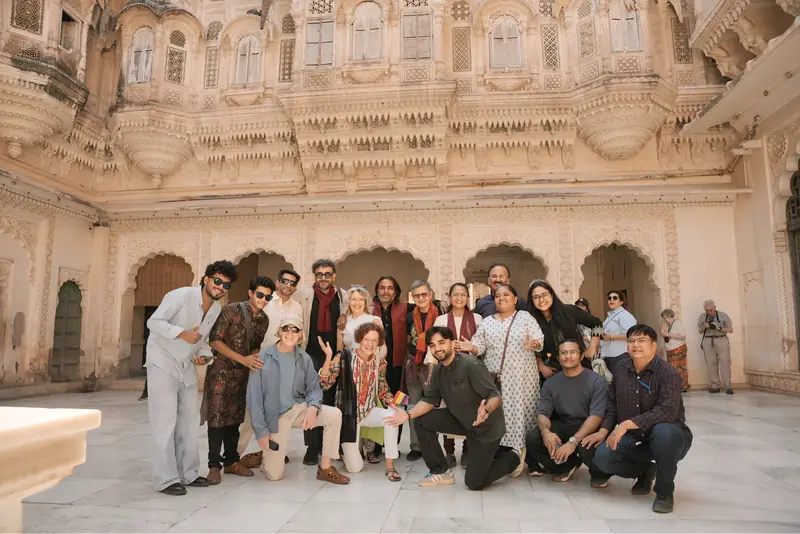 Retreat guests and musicians together in a marble courtyard in Jodhpur
